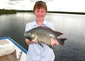 Kirsty catches a fish in Botswana